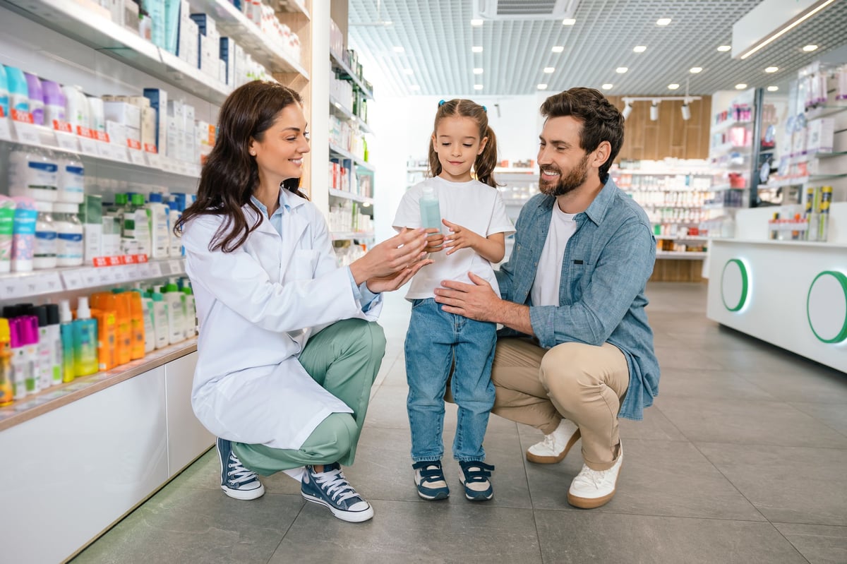 Pharmacist helping a family at the pharmacy counter